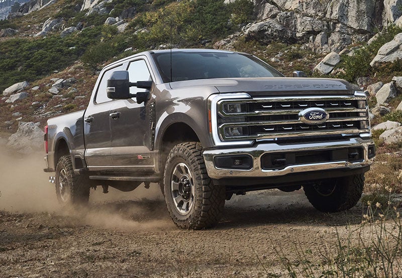 Red and silver Ford SUVs parked outside Speck Ford dealership