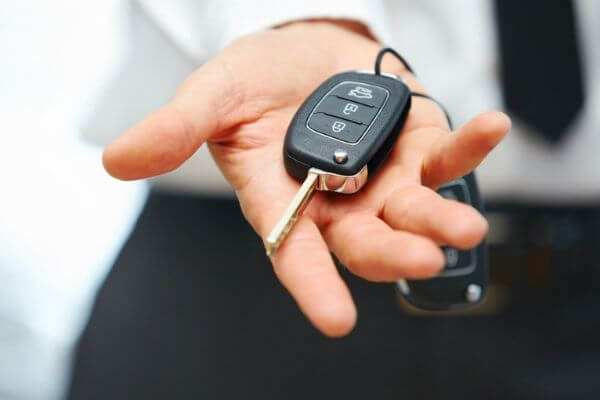 salesman holding car keys